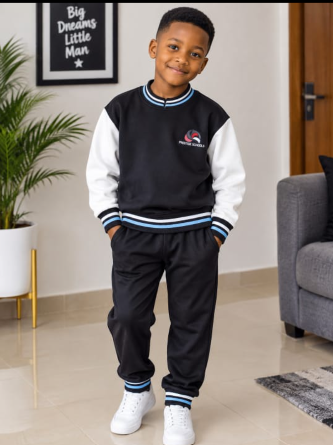 Student wearing a black and white school tracksuit with light-blue striped trim and an embroidered school crest